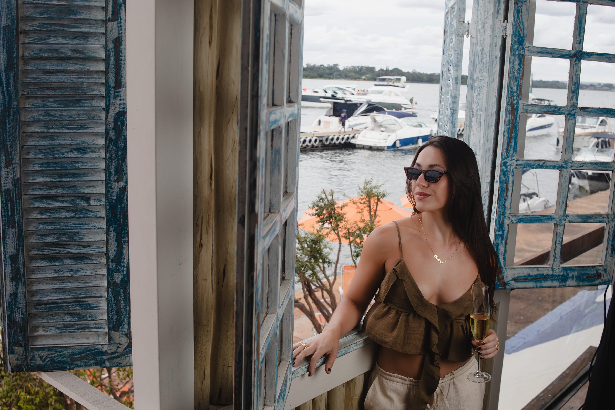 Cristina olhando o horizonte a partir de uma varanda com vista para a marina